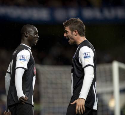 Newcastle United's Papiss Cisse (L) is c
