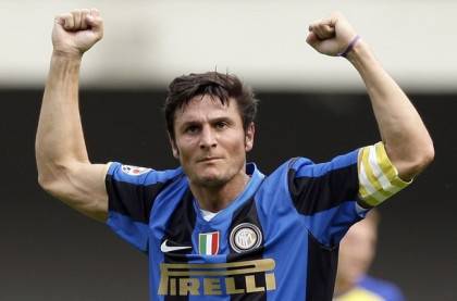 Inter Milan's Zanetti celebrates after a goal scored by his teammate Balotelli against Chievo during their Italian Serie A soccer match at the Bentegodi Stadium in Verona